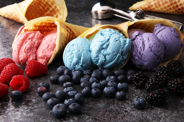 Set of ice cream scoops of different colors and flavours with blueberries, raspberries and...
