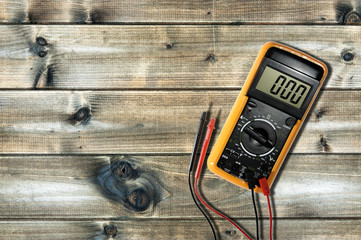 Close up from above of work tools on electrical installations, on an antique wooden table.