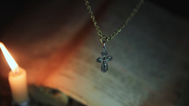 The candle lights the cross on the chain above the psalter