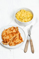 Traditional German or Austrian Wiener Schnitzel or Schnitzel Wiener Art, breaded and pan-fried butterfly cutlet of pork, veal of chicken meat served with homemade potato salad