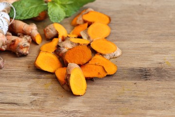 Fresh turmerric on wood background