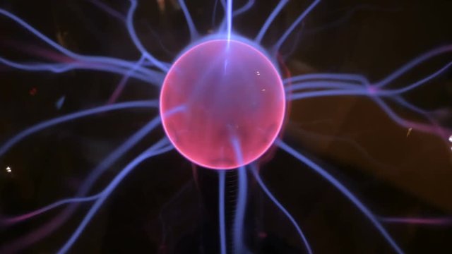 Close up view of plasma ball with many energy rays inside. Electricity and physics concept