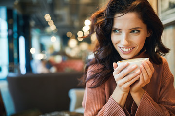 woman drinking coffee in a cafe - 188624737