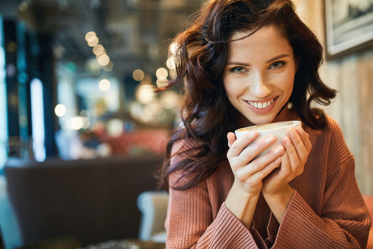 woman drinking coffee in a cafe