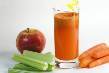 Fresh, healthy, homemade carrot juice in a glass with carrots, apple and celery stalks, Vegetable juice.