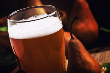Spicy homemade cider of autumn brown pears, vintage wooden background, rustic style, selective focus