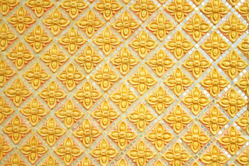 Gold wall background with seamless patterns in Thai temple