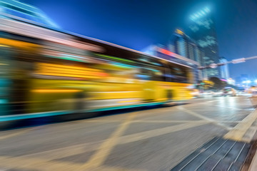 Fototapeta na wymiar Bus speeding through night street in the city.