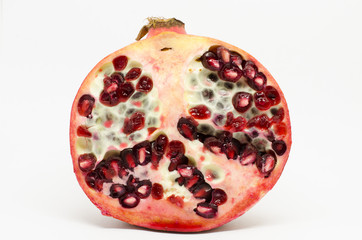 cross section of freah pomegranate fruit isolated on white background