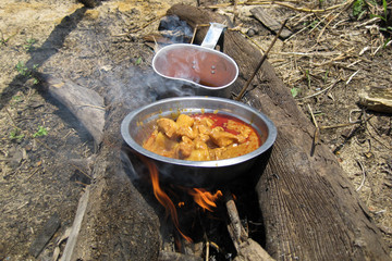 Making  chicken in the fireplace at camping trip