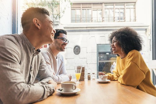 Group Of Happy Friends Chatting In The Coffee Shop.