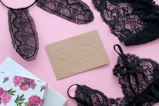 Top view black underwear, bra, lingerie, lace bunny ears, gift boxon, empty blank on pink background. Sewing of underwear, handmade.