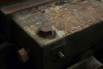 Grain Image: Close up of old machine factory made of steel and used in the past. Broken and rustic machine left over in abandon factory. Image of aged equipment with rust and gear part.