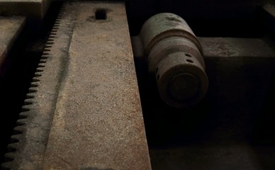 Grain Image: Close up of old machine factory made of steel and used in the past. Broken and rustic machine left over in abandon factory. Image of aged equipment with rust and gear part.