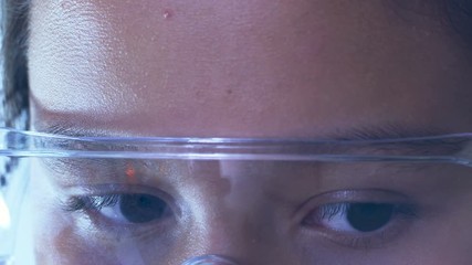 Close up of young girl wearing safety glasses