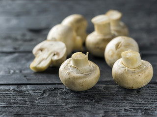 Fresh mushrooms on a rustic wooden table. Vegetarian food is on the table.