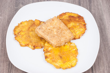 Fried plantain toston (patacon) with fried cheese