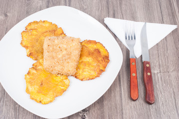 Fried plantain toston (patacon) with fried cheese