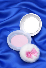 Face powder on blue  background 