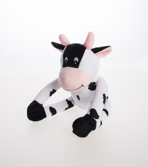 toy or cow soft toy on the background.