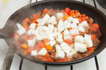 cooking wok with beef, carrots and eggplant