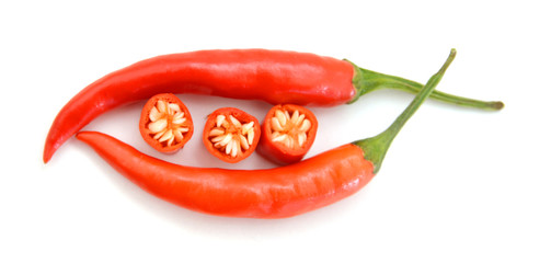 Sliced fresh red chillies isolated on a white background.