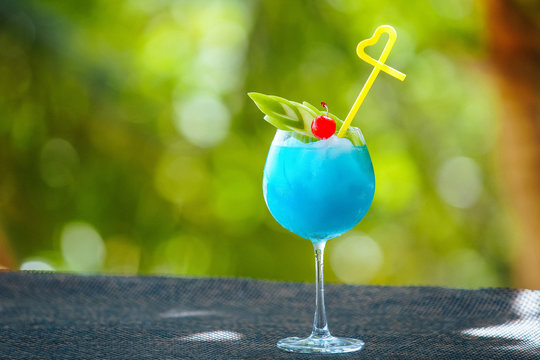 A Refreshing Blue Cocktail On A Green Background. Blue Lagoon. Bikini Martini. Turquoise Margarita