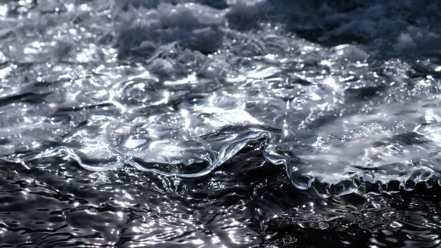 Video of closeup mooving along tracery edge of an ice floe on Altai creek in Spring season
