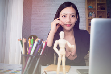 Young Asian woman working at a desk in business sector