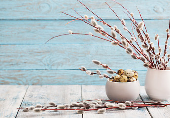 Willow branches and quail eggs on a wooden background © Maya Kruchancova
