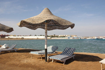parasols and sun loungers on the beach	
