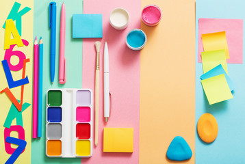 school supplies at  colorful paper background texture