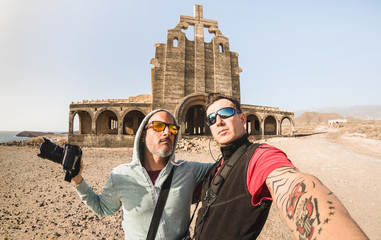 Adventurous best friends taking selfie at abandoned place in Tenerife - Wanderlust travel lifestyle enjoying moments and sharing happiness - Trip together around the world as alternative lifestyle