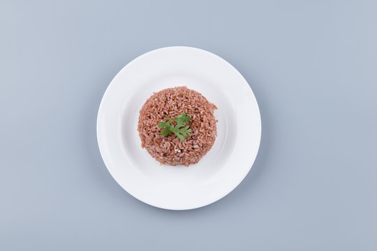 Brown rice in a white plate dish