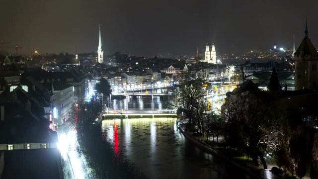 Aerial time lapse of Zurich skyline and Limmat river at night.