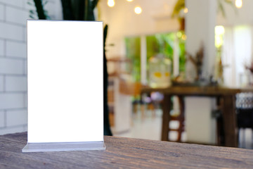 Mock up Menu frame standing on wood table in Bar restaurant cafe. space for text