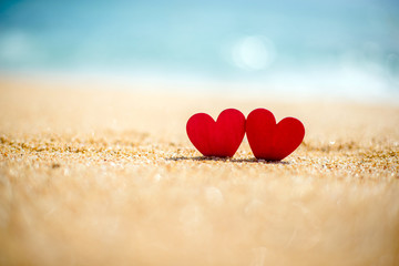 Fototapeta premium romantic symbol of two hearts on the beach 