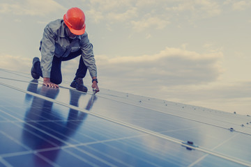 engineer working on checking and maintenance equipment at industry solar power; engineer and technician discuss to  find problem of solar panel.