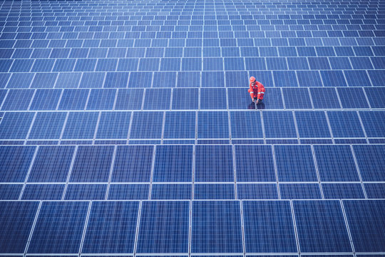 engineer working on checking and maintenance equipment at industry solar power; engineer and technician discuss to  find problem of solar panel.