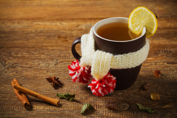 Cup with scarf with hot tea.