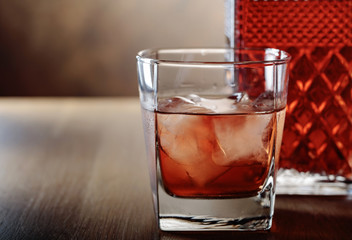 Glass of scotch whiskey and natural ice .
