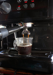 Coffee maker machine pouring coffee into cup. Coffee machine pouring coffee to glass coffee cup, Its coffee break time.