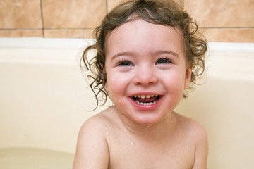 happy funny baby laughing and bathed in the bath