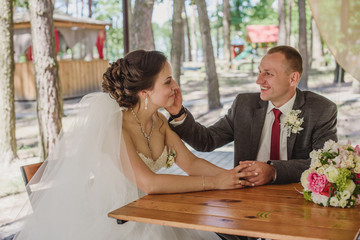 Wedding. Wedding day. Beautiful bride and elegant groom walking after wedding ceremony. Luxury bridal dress. Bride and groom at wedding day
