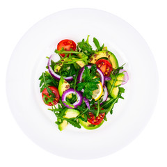Plate with salad of fresh vegetables with avocado, isolated on white background