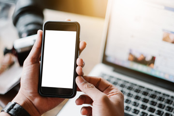 Close up of man using mobile smart phone,sending massages on the garden.having sunbath.Phone with black screen,texting,video calls,
