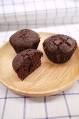 Homemade Chocolate Cupcake and Half One on Wooden Plate 2