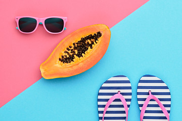 Papaya Tropical Fruit. Bright Sweet Color. Flat lay. Hot Summer Vibes. Trendy fashion Accessories Set. Minimal Style. Pink papaya, Sunglasses on Yellow