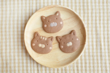 Three Pieces of Homemade Chocolate Cookies Cat Face  in Wooden Plate   