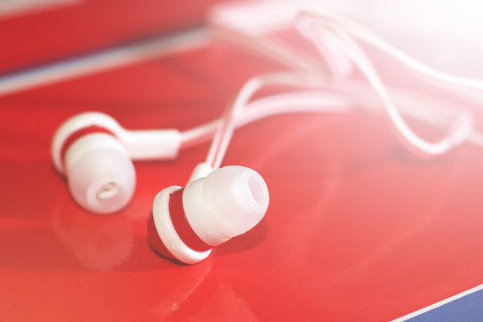 Close up on red earbuds, a trendy device for the player